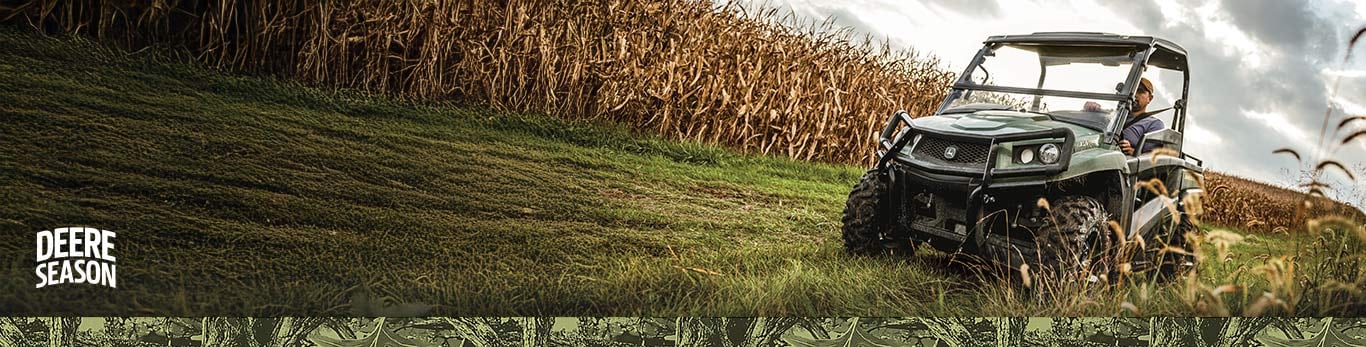 Gator Utility Vehicle driving next to corn crops.