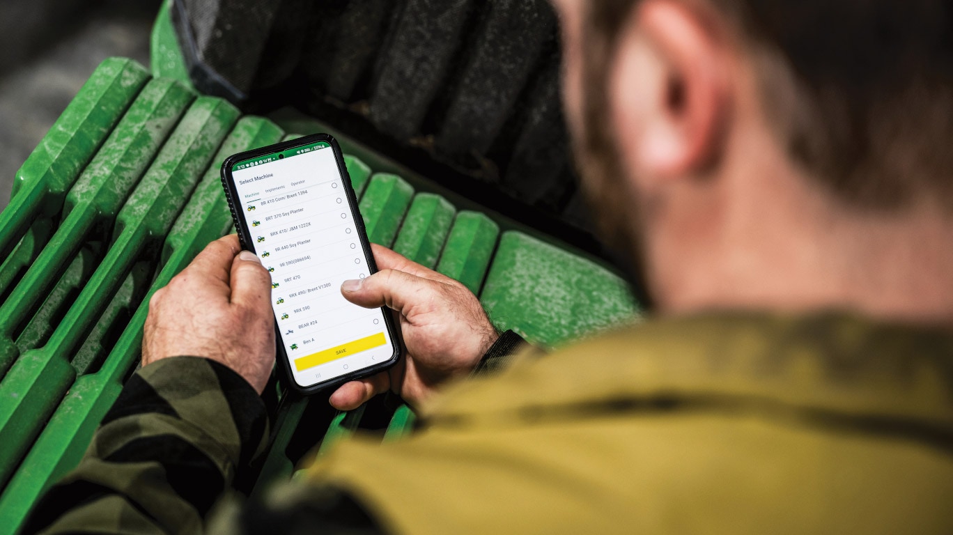 Customer checking John Deere Financial account details on a smartphone.