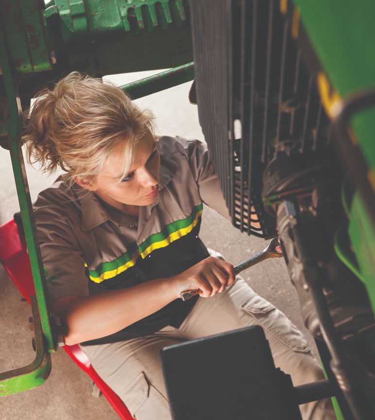 Service technician working on a tractor