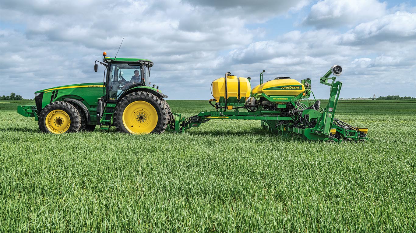 Tractor with an input attached out in a field