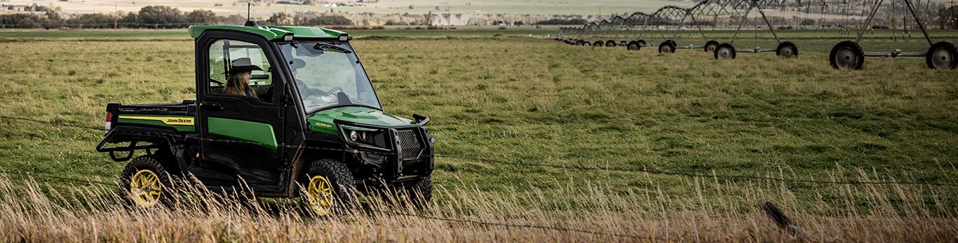 Gator XUV835R driving in a field