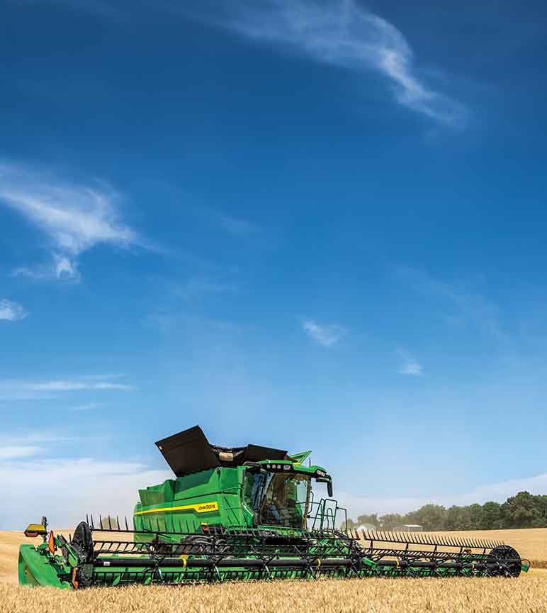 Front-angled photo of the new S7 Combine harvesting wheat