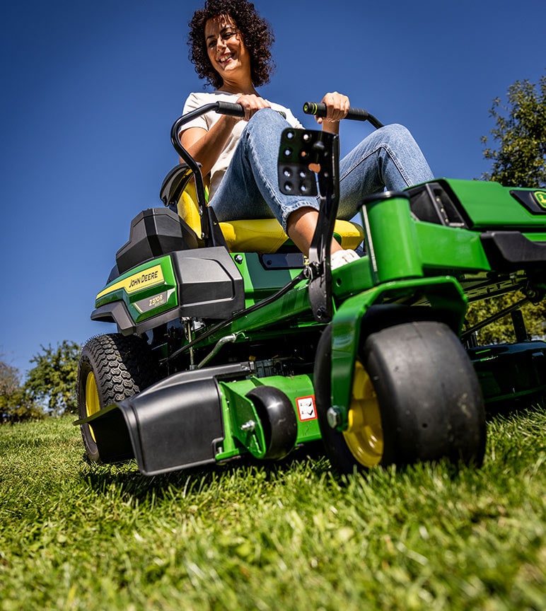 Woman mowing grass with John Deere Z370R Zero-Turn mower