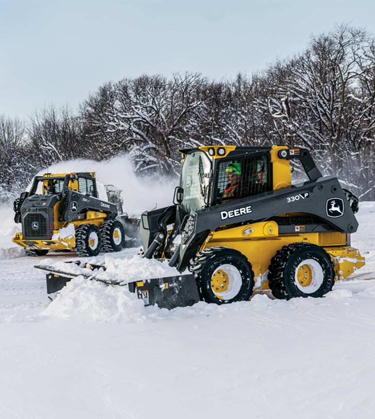 The 330 P-Tier Skid Steer with the Snow Pusher SP10C and the 334 P-Tier Skid Steer with the Snow Blower SB84S