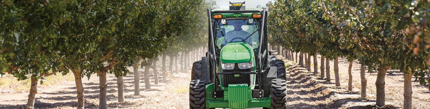 Tractor driving through a vineyard