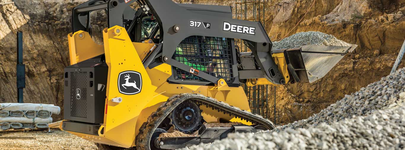 317 P tier compact track loader picking up gravel in construction site