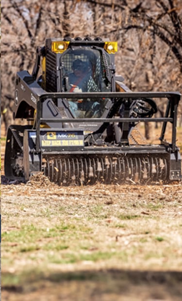 A 335 P-Tier CTL equipped with an MK76 mulching head navigates through an autumn forest