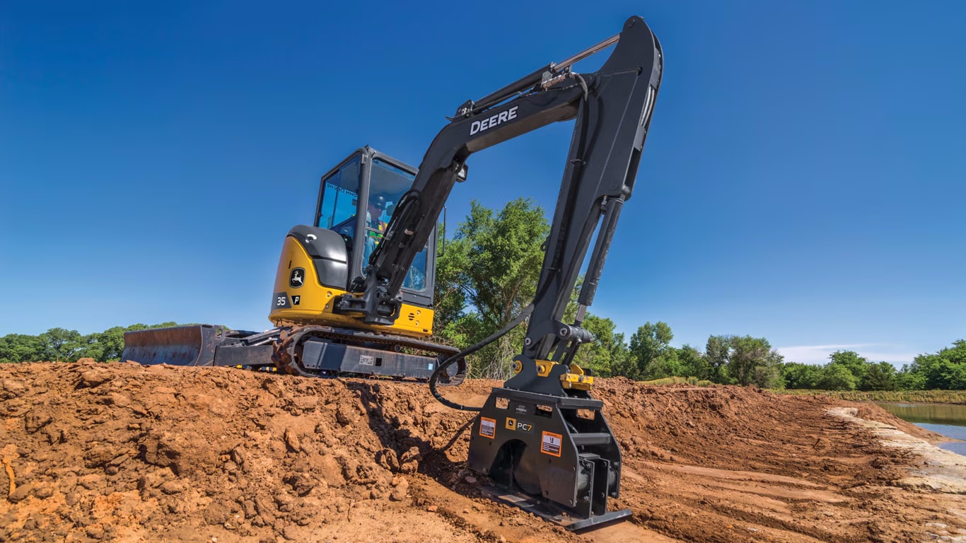 35 P-Tier compacting dirt by a water feature