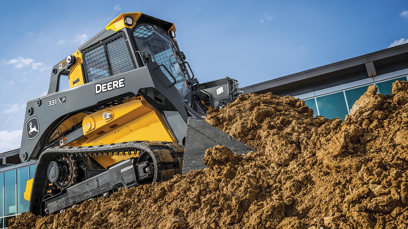 John&nbsp;Deere 331 P-Tier compact track loader moving dirt on jobsite.