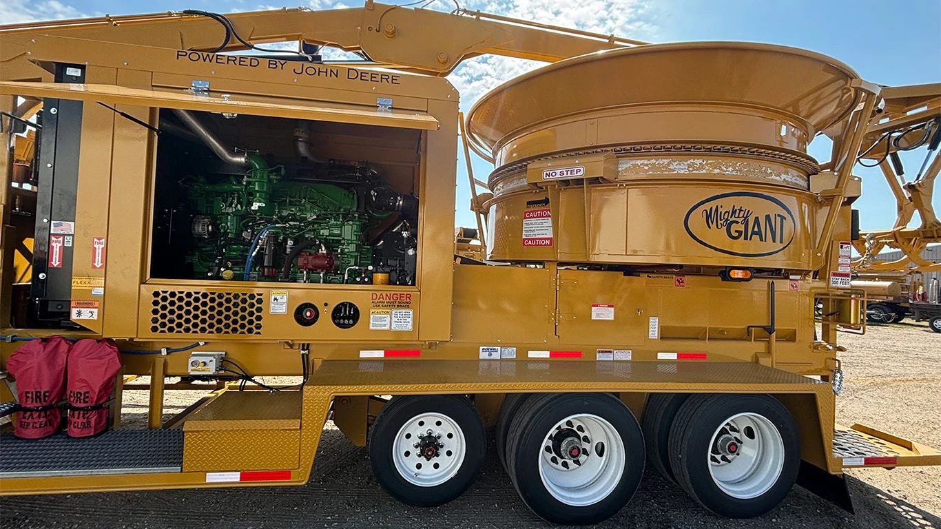 The JD18 industrial engine in a yellow Mighty Giant hay grinder on a farm