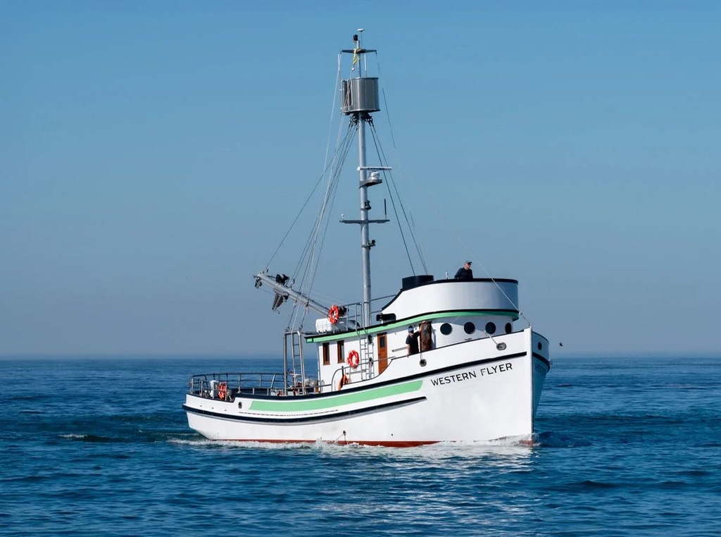 The Western Flyer vessel on the water, powered by a John Deere marine engine.