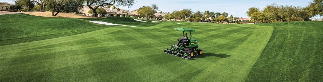 Image of a golf course with person using a mower