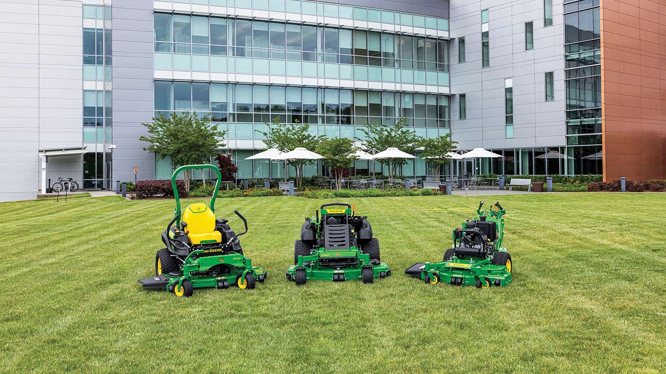 Line-up of John Deere's new commercial mower offerings in front of a building