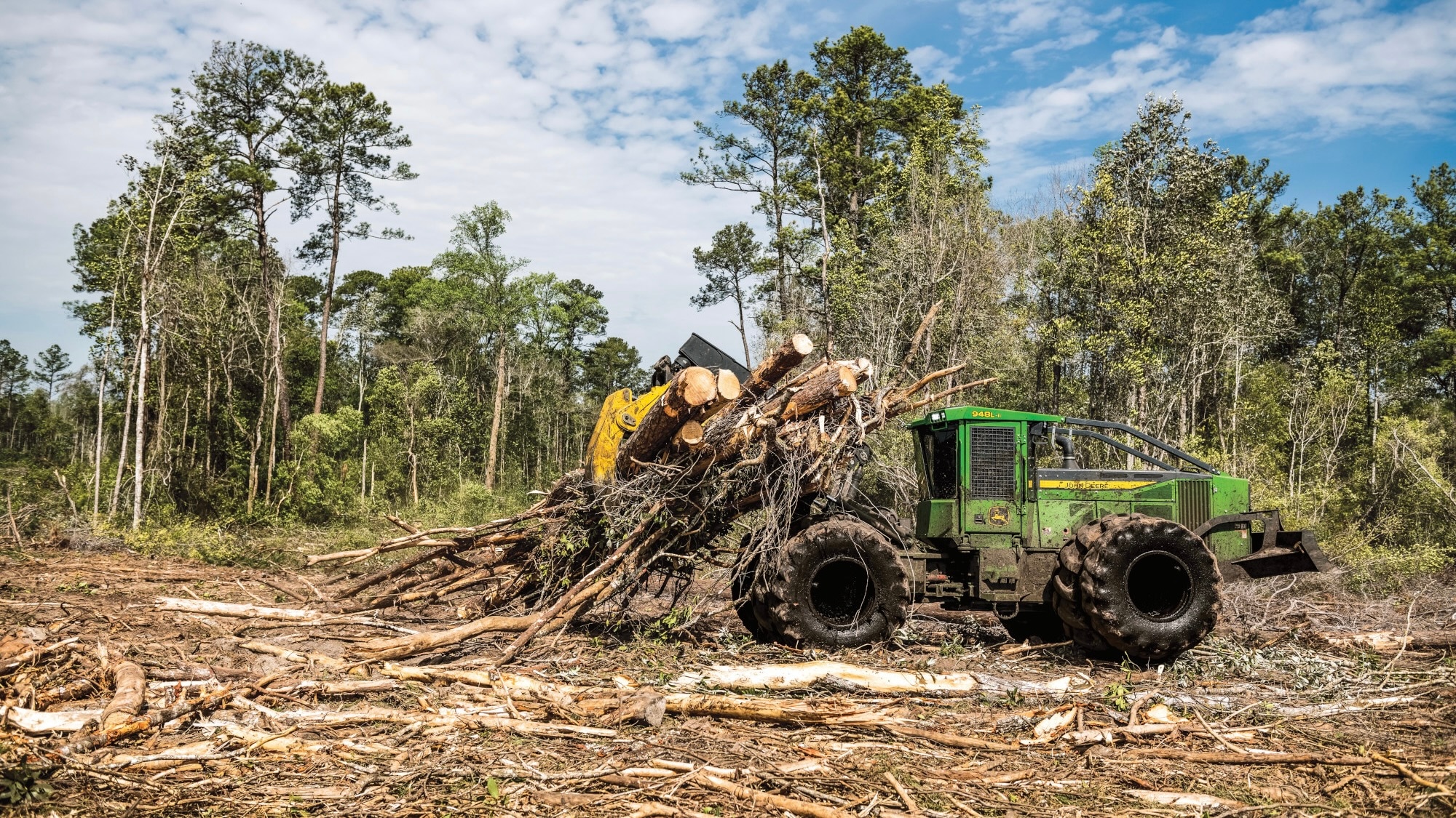 948L Grapple Skidder with skidder transmission assurance program picking up cut trees