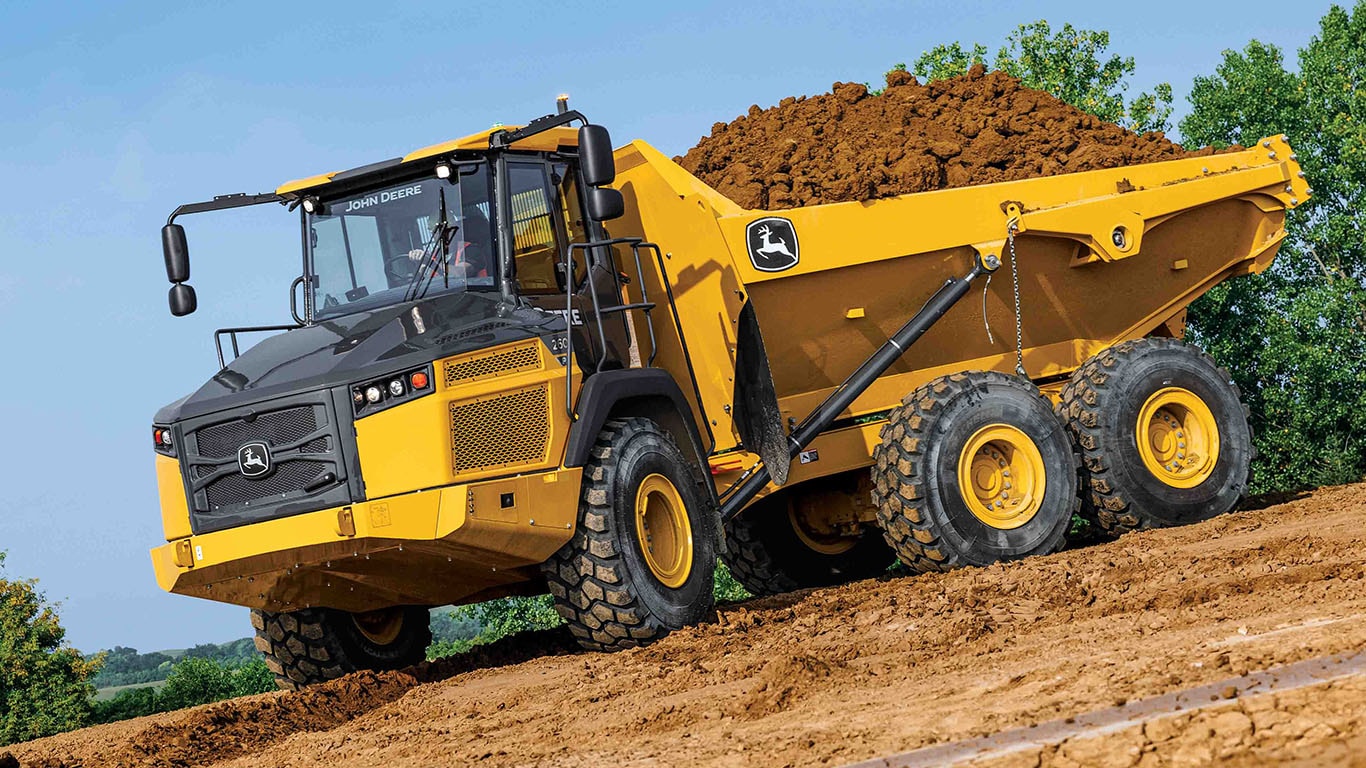 The new John Deere 260 P-Tier Articulated Dump Truck moving a load of dirt