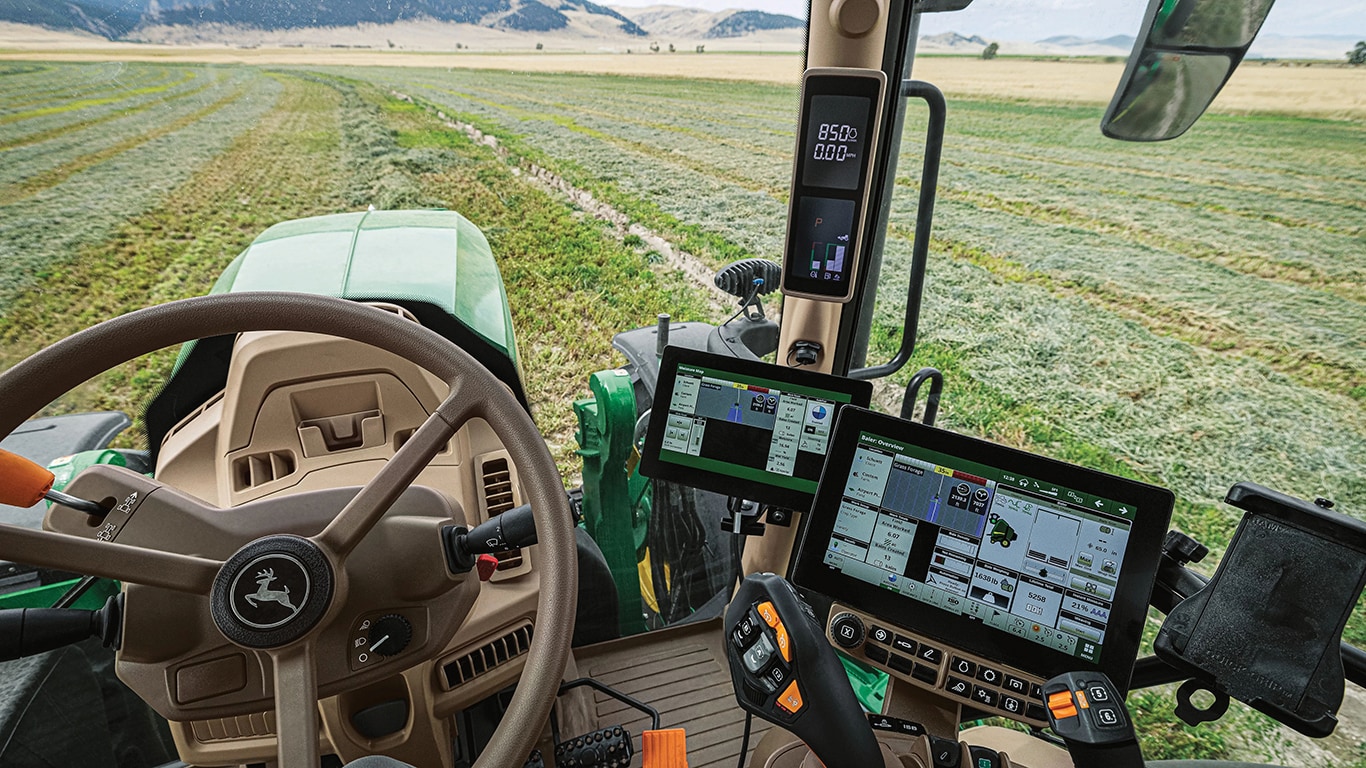 Inside the operator's cab of a John&nbsp;Deere 6R Series Tractor.