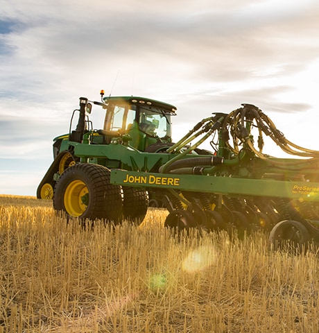 A John Deere 9RX Series Tractor using a No-Till Air Drill planter in Montana, United States wheat field