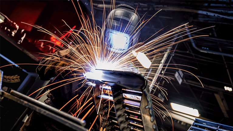 A welder at Harvester Works in East Moline, Illinois, USA