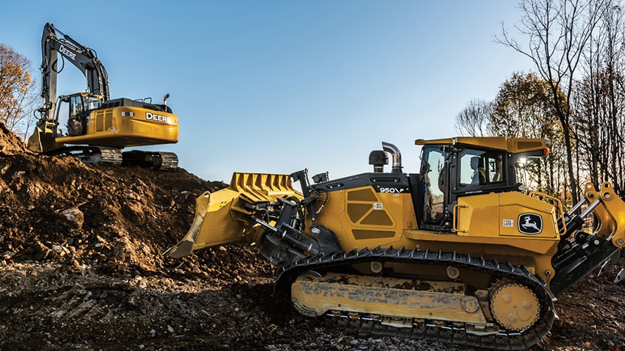 A John Deere dozer and excavator at a worksite