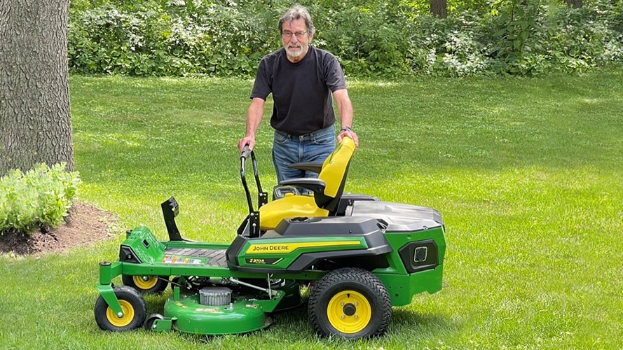 Ralph Nudo next to his John Deere Z370R electric mower