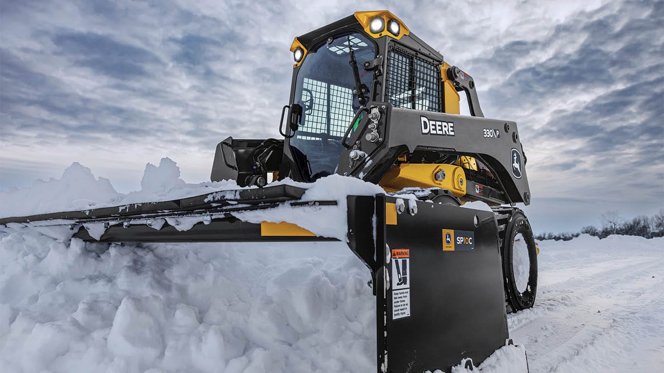 Skid steer with snow pusher to clear snow.