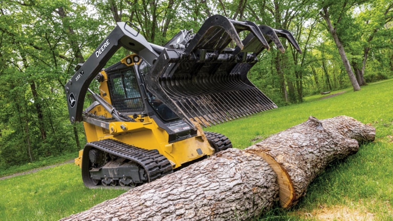 333 P-Tier compact track loader with grapple attachment ready to pick up and move large logs. (3rd thumbnail)