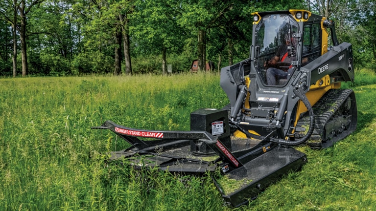 333 P-Tier compact track loader using rotary cutter to trim grass and brush. (4th thumbnail)