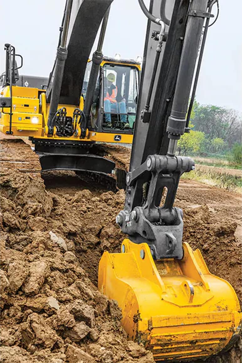 John Deere 350 P-Tier excavator digs a hole.