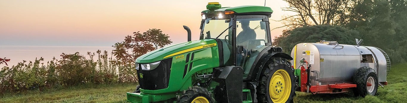 A 5130ML Tractor pulling equipment in a field