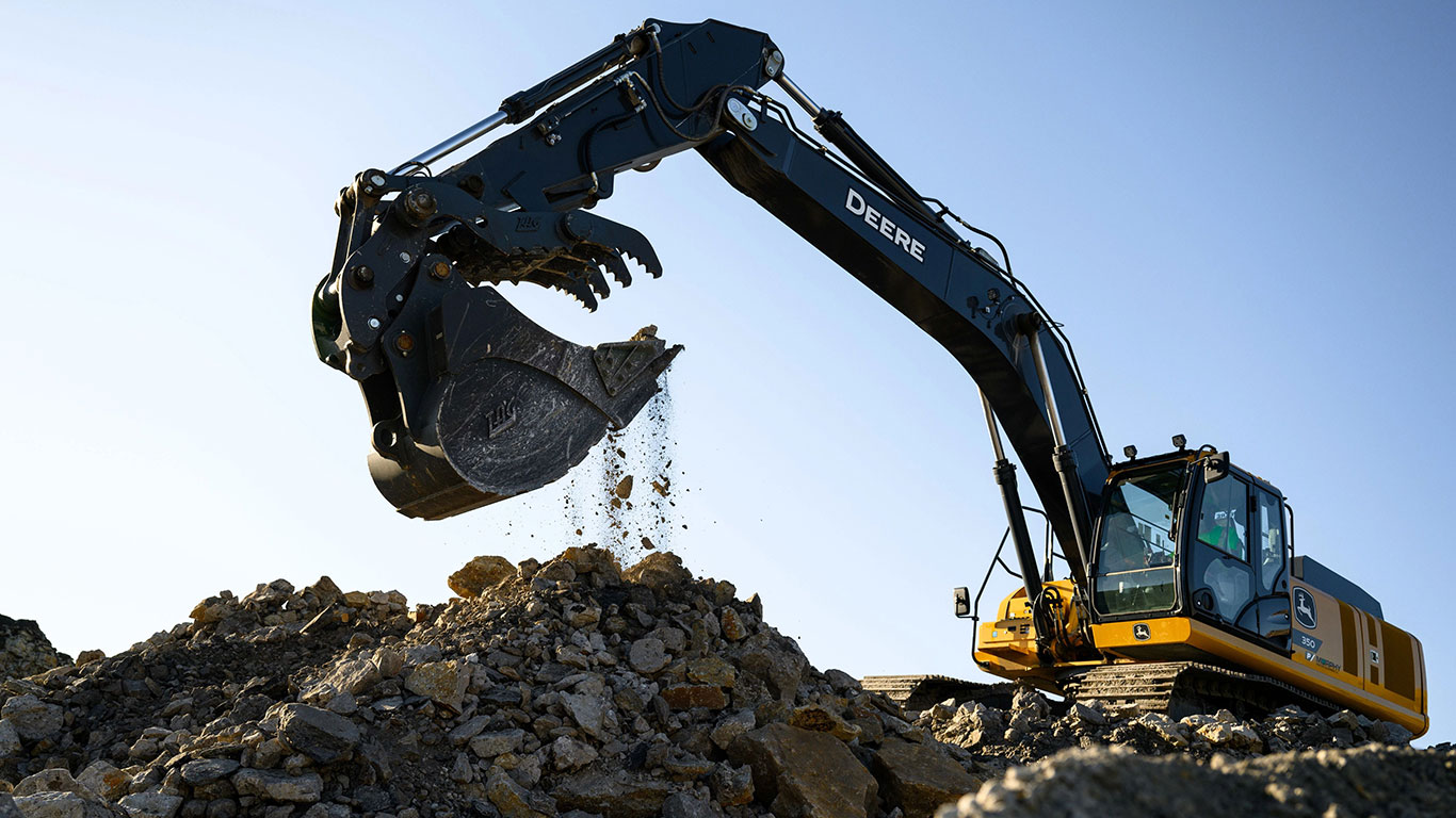 The John Deere 350 P-Tier Excavator skillfully curled its bucket after efficiently filling up with rock.