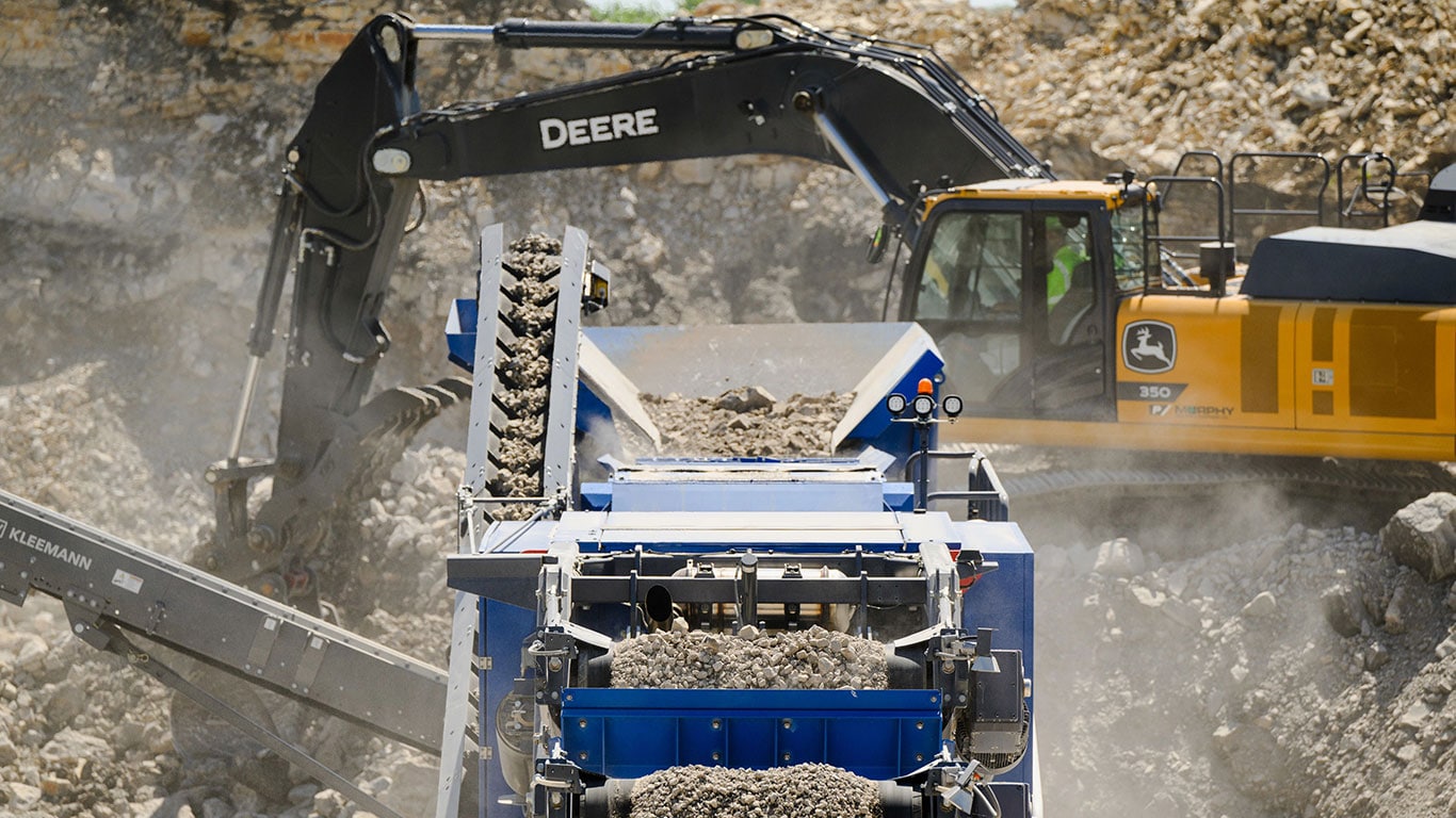 An excavator loads gravel in a quarry