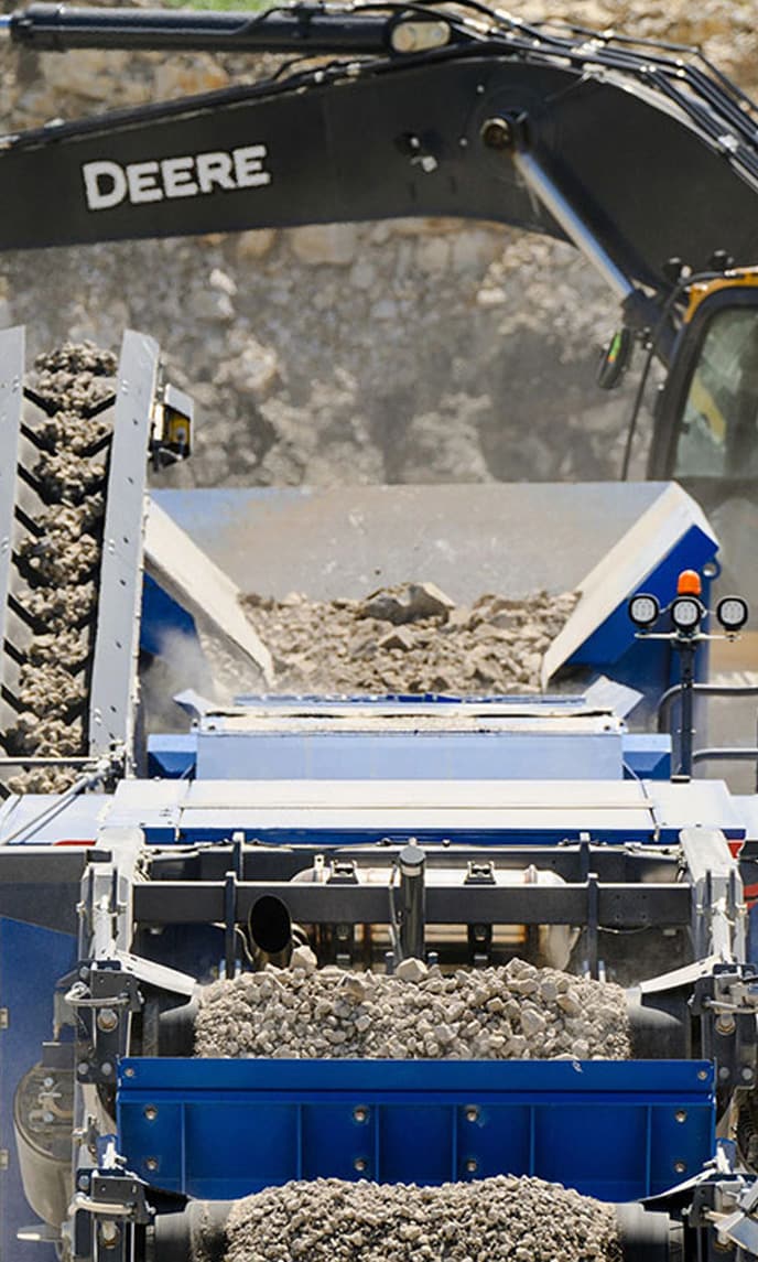 An excavator loads gravel in a quarry