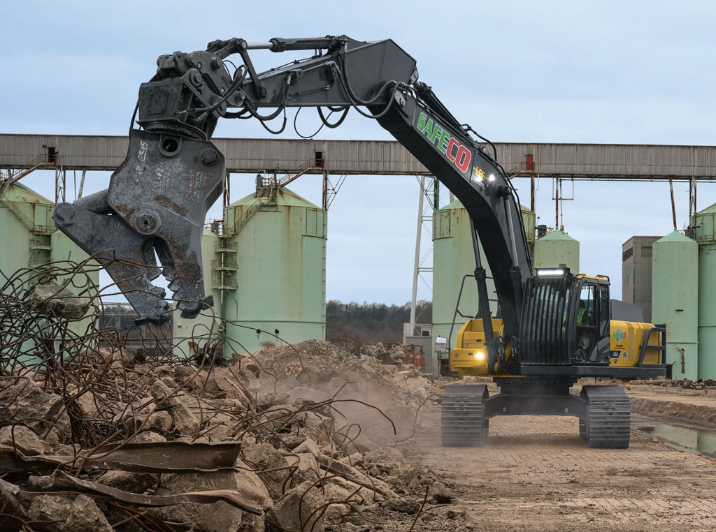 Large excavator clearing debris from a job site