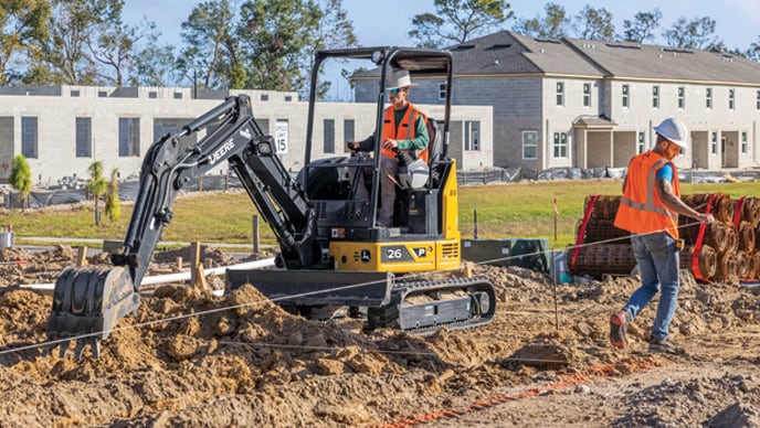 The bucket of a 26P-Tier Compact Excavator digging into the ground