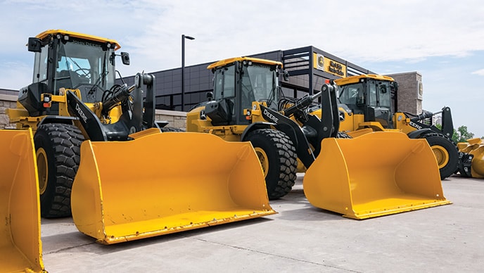 wheel loaders lined up in a row