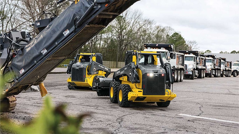 330 G-Tier Skid Steer and 333 G-Tier Compact Track Loader on a work site