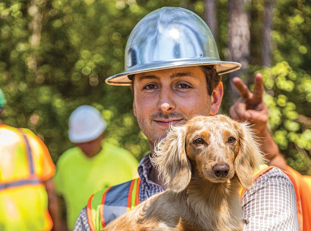 Josh Lewis holding pet dachshund