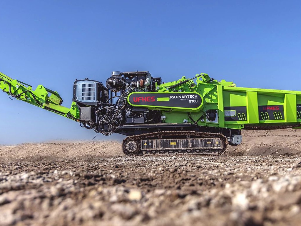 A lime green Ragnartech 9700 from Ufkes Greentec on gravel.