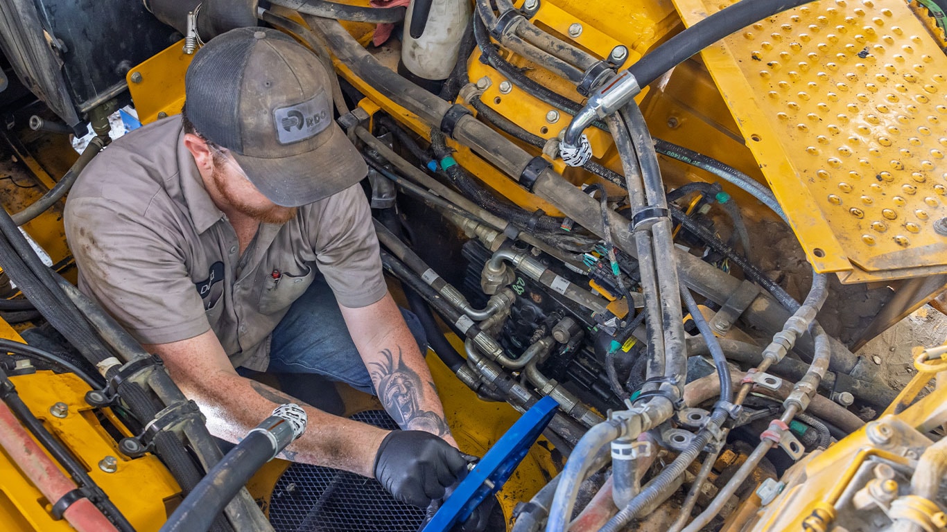 Technician servicing a piece of heavy equipment.