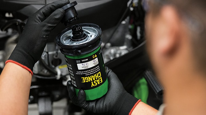 Person holding an easy change oil filter
