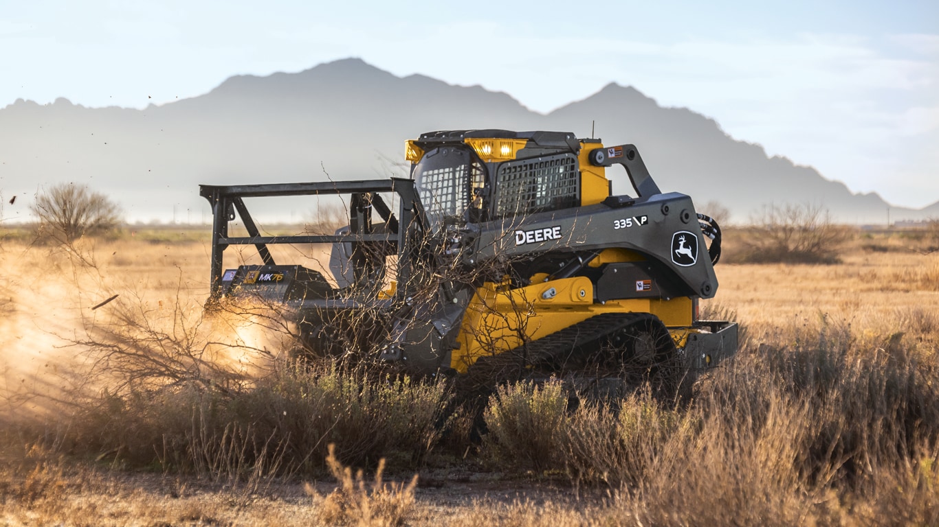 335 P-Tier compact track loader cutting with MK76 mulching head attachment