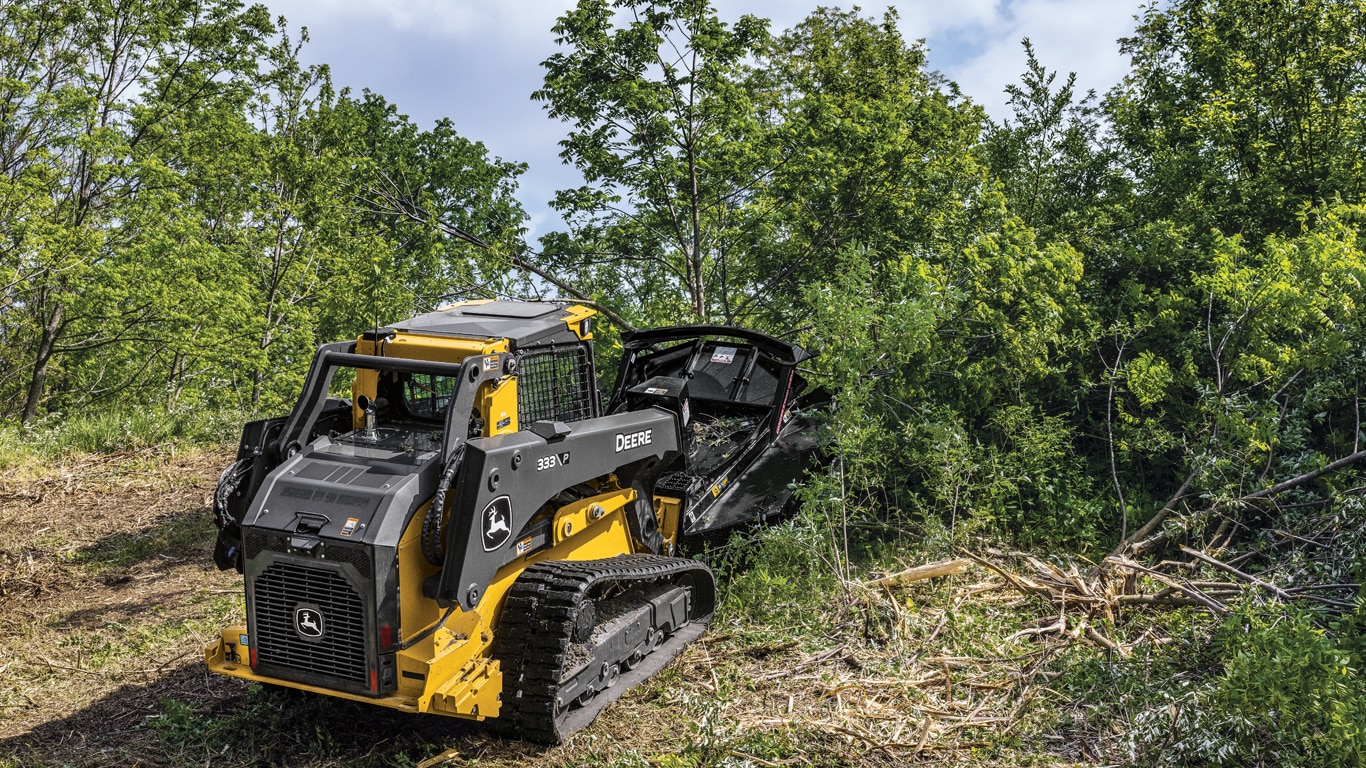 333 P-Tier compact track loader using a RX84 rotary cutter to clear bushes