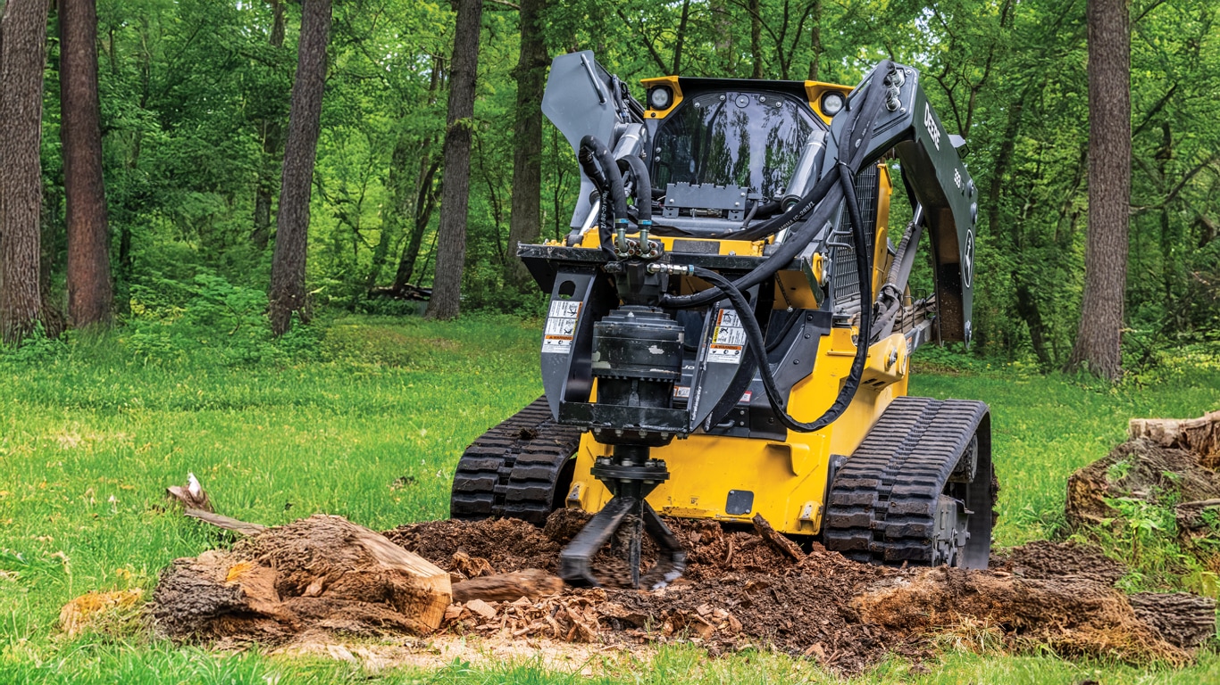 Compact track loader using a SS30 stump shredder to remove stump from ground