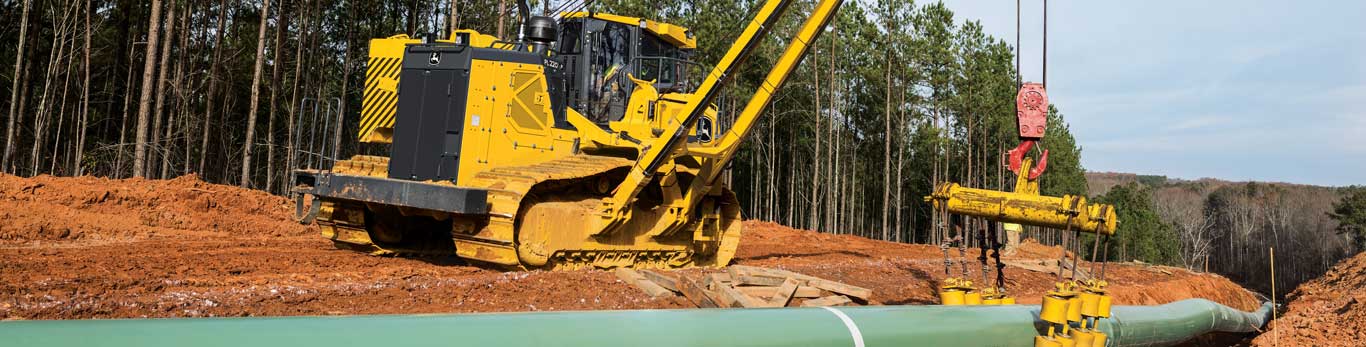 John Deere PL220 working on jobsite to lay pipe underground.