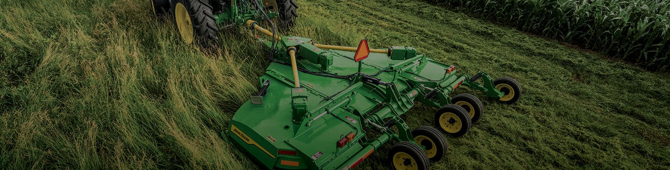 close up of rotary cutter being pulled in a field