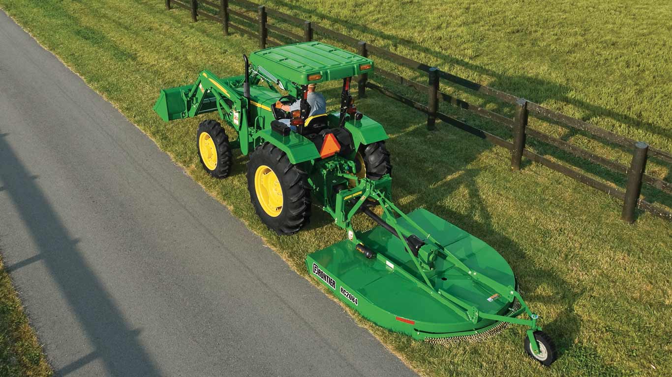  RC20 Series Cutter attached to utility tractor cutting grass on the side of street.