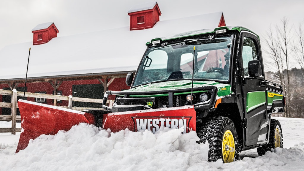 XUV 845R pushing snow with a Western V Blade