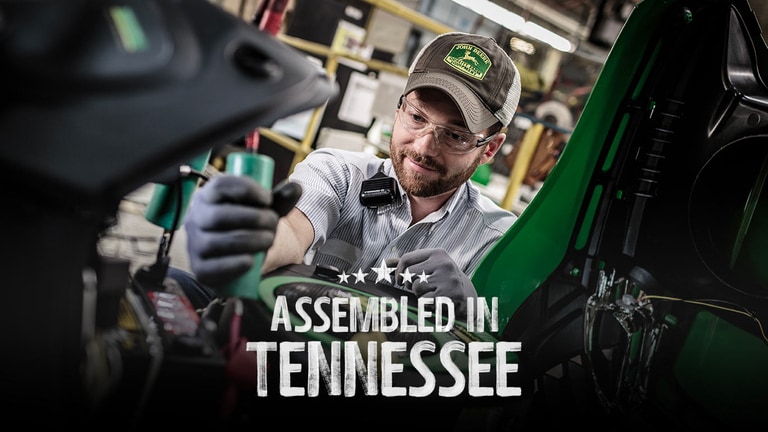 A person assembling a piece of John Deere equipment at the factory in Tennessee.