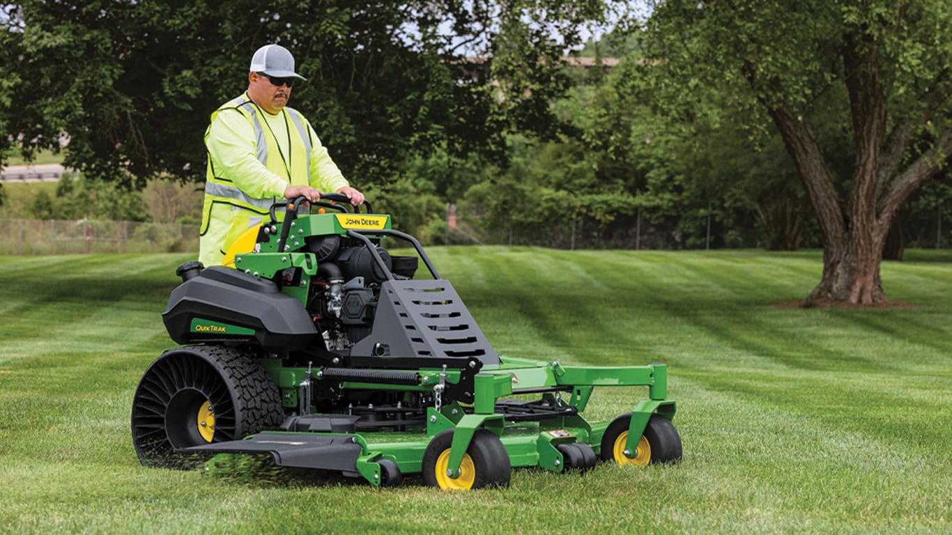 man driving a QuikTrak mower with a 72 in 7Iron PRO deck and airless tires