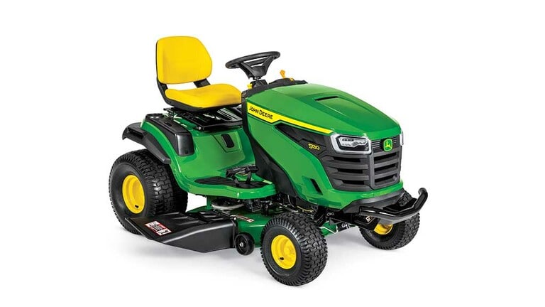 A front-right-facing green riding mower with a yellow seat and green mowing deck on a white background. (4th thumbnail)